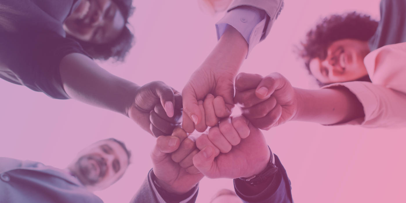 Young professionals joining their hands in unison