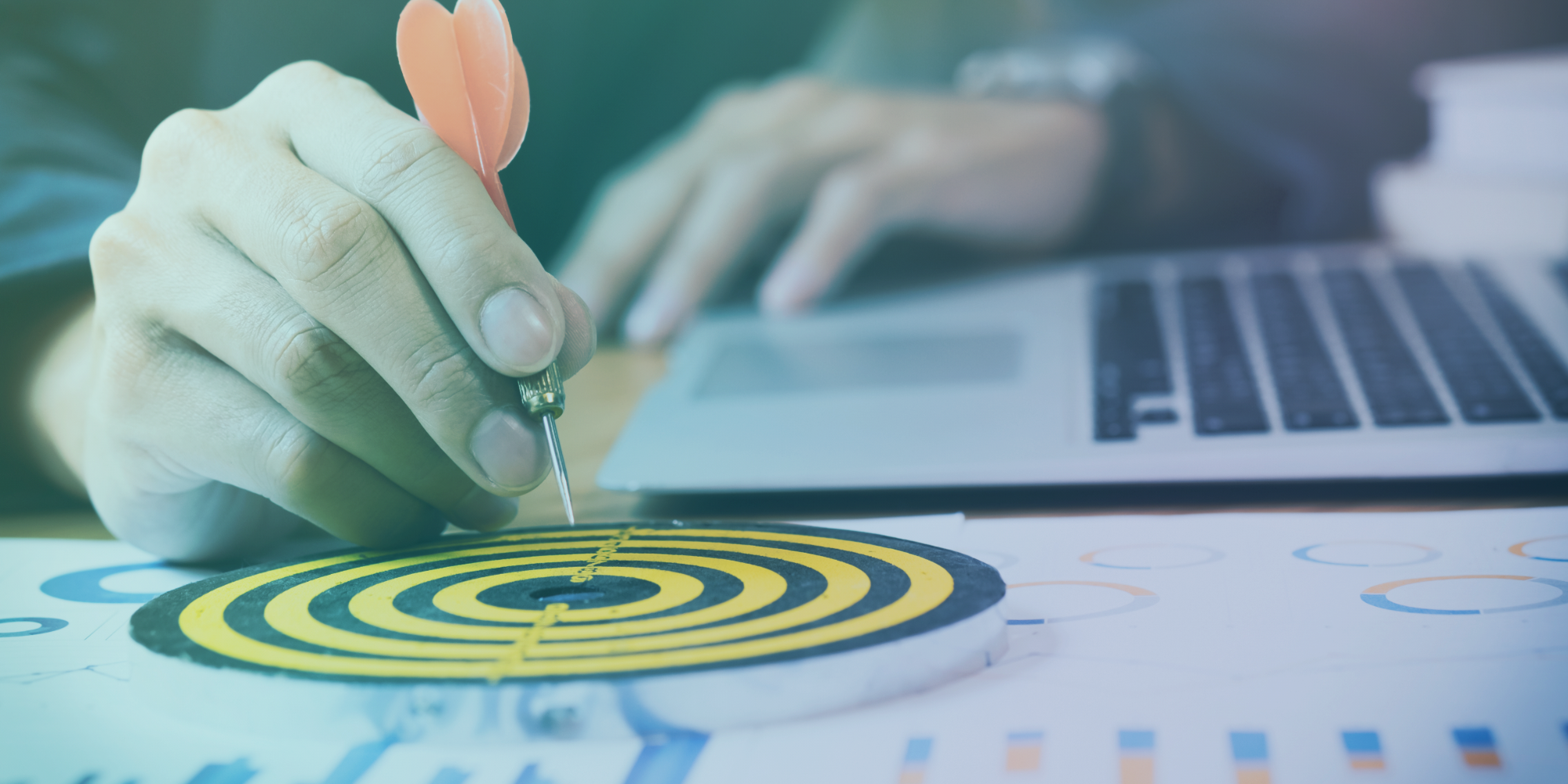Businessman placing a dart in the bull's eye of a dartboard